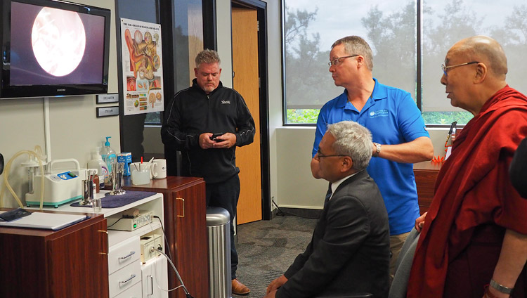 Su Santidad el Dalái Lama observando cómo su traductor se somete a un examen de oído en la Fundación de Tecnología Auditiva Starkey en Minneapolis, MN, EE.UU., el 22 de junio de 2017. Foto de Jeremy Russell/OHHDL